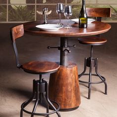 a table with two stools and a wine bottle