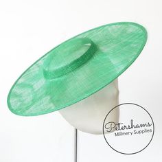 This emerald cartwheel hat base is a classic shape that has sprung into popularity in the past year. Made from 2 layers of stiffened sinamay, these cartwheels are ready to trim and are fitted with a petersham ribbon on the inside crown edge. Simply add a comb or headband to secure to the head.Hat base measures:Width: 35.5cm (14 inches)Crown Width: 13.5cm (5.3 inches)Crown Height: Approximately 3.5cm (1.7 inches)For even more millinery supplies you can find us here:www.etsy.com/shop/PetershamsAll Green Straw Hat With Adjustable Flat Brim, Adjustable Green Hat Bands For Kentucky Derby, Adjustable Green Hat Band For Kentucky Derby, Green Adjustable Hat Bands For Kentucky Derby, Green Brimmed Straw Hat, Green Adjustable Straw Hat With Short Brim, Green Straw Hat With Short Brim, Green Headpiece For Church, Green Wide Brim Fascinator For Kentucky Derby