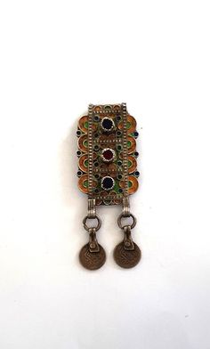 Morocco old Silver Amulet or Talisman "Hirz" or "Herz" Pendant, Enamel and Glass cabochon South of Morocco, Tiznit: Berber people, richly decorated enamelled amulet, worn on the chest as a lucky charm, on the back of the amulet a box in which a lucky charm or verses from the Koran can be placed Early 20th century, Height:  85 mm Width:  35 mm  Weight (Gr.): 20.40 grams   Feel free to contact me for any question about this item, I will be happy to answer you as soon as possible. Visit my Etsy Sho Traditional Collectible Jewelry Brooch, Antique Multicolor Brooch Jewelry, Traditional Round Collectible Brooches, Traditional Collectible Round Brooches, Handmade Bohemian Brooches For Collectors, Antique Ceremonial Jewelry With Inlay, Antique Multicolor Jewelry For Ceremonial Occasions, Bohemian Multicolor Brooch Jewelry, Collectible Amulet Jewelry For Festivals