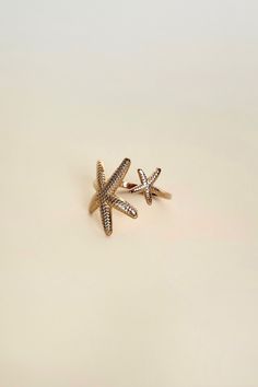 Ready to add some beachy vibes to your look? This adjustable starfish ring is the perfect accessory for your next vacation. No need to worry about sizing - it fits every finger perfectly. Get ready to make a splash! All of our jewelry comes with a free jewelry pouch and cloth to keep your pretties safe and clean. Details Color: PVD 18K Gold PlatedMaterial: Stainless SteelSize: Adjustable Care Guide Store in a dry, cool place away from sunlight i.e. Blush & Bliss pouch Gently wipe with a soft clo Starfish Jewelry For Vacation, Adjustable Starfish Charm Jewelry, Beachy Starfish Jewelry For Vacation, Starfish Jewelry For Beach Season Gift, Starfish Shaped Jewelry For Beach Season Gift, Summer Starfish Charm Star Shaped Jewelry, Summer Starfish Charm Star-shaped Jewelry, Summer Star-shaped Starfish Charm Jewelry, Adjustable Star-shaped Jewelry With Starfish Charm