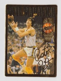 an autographed basketball card with a man holding a ball in his hand and wearing yellow socks