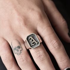 A handmade sterling silver 925 initial octagon shape signet ring with a frame and 3D letter and an oxidized background. Each ring is cleaned and polished with care. The weight of the ring may vary according to size. Top measurements: Width - 14.5mm | Height - 16.5mm Approx weight: 9.18gr This awesome ring is available in more shapes! Click here to see: Rectangle: https://www.etsy.com/il-en/listing/568045759/letter-initial-signet-ring-silver-letter Round: https://www.etsy.com/il-en/listing/568044 Luxury Men's Initial Ring With Engraving Option, Luxury Men's Initial Promise Ring, Luxury Heirloom Men's Ring With Initials, Monogrammed Sterling Silver Rings, Silver Open Ring With Monogram Engraving, Silver Monogram Engraved Open Ring, Vintage Silver Monogram Engraved Ring, Adjustable Silver Monogram Ring, Vintage Silver Monogram Rings