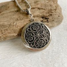 "Please note: If you need more than one, multiple quantities are available upon checkout. Timeless and classic, this gorgeous antiqued silver locket will become a special addition to your jewelry collection. Lightweight and beautiful with any neckline, dressed up or casual. The locket is 32mm in diameter, antique silver and opens for a secret place to keep pictures, messages, or whatever you like. The locket is plated brass and has a stainless steel rolo chain with a lobster clasp. You may choos Antique Jewelry With Engraving Option For Anniversary, Engraved Locket Necklace With Round Pendant, Classic Silver Medallion Necklace With Round Pendant, Sterling Silver Locket Necklace For Vintage Collection, Antique Silver Locket Necklace From Vintage Collection, Ornate Silver Jewelry With Engraving Option, Antique Silver Jewelry Gift, Antique Silver Jewelry As A Gift, Antique Round Pendant Jewelry With Engraving Option