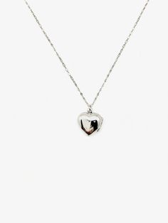 Embrace the nostalgia of the past and celebrate your love story with this heart-shaped sterling silver locket. A symbol of enduring love, this vintage gem is not just jewelry; it's a classic piece that spans decades. Discover timeless love with our Silver Jane Locket, a unique vintage treasure straight from the 1960s. The secure click-shut design ensures your cherished memories stay safely tucked away. The 17" sterling silver chain elegantly complements the locket, adding a touch of sophisticati Dainty Open Heart Locket Necklace, Dainty Open Heart Locket Necklace With Heart Charm, Dainty Double Heart Locket Necklace With Charm, White Gold Vintage Charm Pendant Jewelry, Dainty Heart Pendant Locket Necklace With Charm, Dainty Double Heart Locket Necklace, Dainty Heart Locket Necklace With Charm, Vintage White Gold Pendant Jewelry, Dainty Heart Necklace With Locket