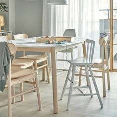 a dining room table with chairs around it