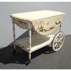 an old fashioned cart with wheels painted white