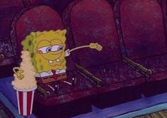 spongebob and his friend are sitting on the seats in the movie theater together