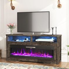 an entertainment center with a fireplace and tv on it's stand in front of a white wall