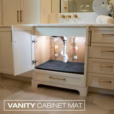 a kitchen with white cabinets and marble counter tops is shown in this image, the cabinet doors are open