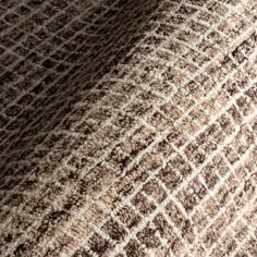 the texture of an upholstered blanket is brown and white