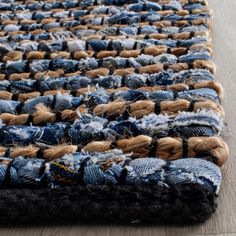 a rug made out of old jeans with a smiley face drawn on the top and bottom