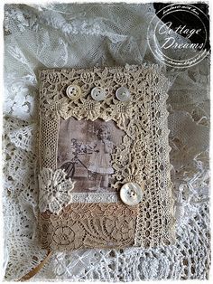 an old photo album with buttons and lace