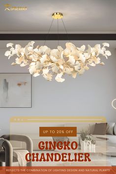 a chandelier with white flowers hanging from it's ceiling in a living room