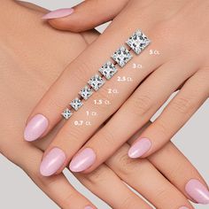 a woman's hand with pink nail polish and diamond ring on it, next to her measurements