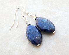 The fall season brings out our natural inclination to be fashionistas. These dark blue lapis lazuli gemstone earrings with pyrite sparkles are trendy, dangly and easy to wear with everything in your closet. Reminds me of the celestial night sky. Handmade with sterling silver earring closures. Great gift for women born in September since lapis lazuli is one of her birthstones.Earring Details:- Earrings are 1.75 inches (4.45 cm) long- Lapis lazuli gemstones are .75 inches tall and .5 inches wide ( Chip Bead Jewelry, Navy Blue Earrings, Bridal Party Jewelry, Great Gifts For Women, Birthstone Gifts, Blue Lapis, Blue Jewelry, Silver Earring, Blue Earrings