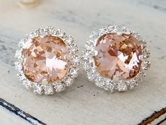 "Blush pink crystal stud earrings, Blush Bridal earrings, Bridesmaid gifts, vintage rose, European halo earrings, silver or gold, weddings Lovely and chic. These earrings have so much sparkle. They would be great as bridal earrings or for any available other day. Perfect gift for bridesmaids or for any available other occasion. They are made of silver plated posts and Swarovski rhinestones, all set in prong setting. The center stone has a cushion fancy cut - real elegant. Blush pink surrounded b Glamorous Pink Bridal Earrings For Wedding, Wedding Pink Sparkling Crystal Earrings, Elegant Pink Sparkling Crystal Earrings, Pink Sparkling Jewelry For Wedding, Glamorous Pink Bridal Earrings, Pink Sparkling Crystal Earrings For Wedding, Pink Sparkling Crystal Jewelry For Wedding, Pink Cubic Zirconia Crystal Earrings For Wedding, Pink Crystal Wedding Earrings