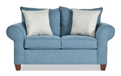 a blue couch with two pillows on it