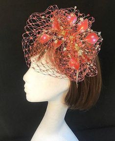 Beautiful coral red veiled fascinator perfect for the bride or guest who wants something beautifully unique and bespoke. This design is a stunning selection of silver wired base glass effect leaves and flowers clustered together amongst a fine layer of veiling and set onto a fine comfort base tiara band. As with all our designs, this piece can be made exact to the image or in any colour combination to match in with your outfit. If a specific colour is required customers can message over an image Gold Fascinator, Red Veil, Veiled Hats, Wedding Fascinators, Coral And Gold, Silver Wire, Bespoke, Color Combinations, Mother Of The Bride