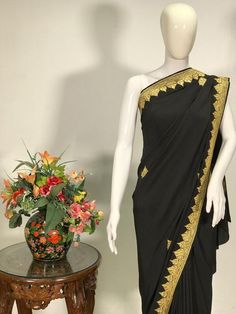 A Marvellous Embroidered Kashmiri Saree, which you can wear at any party or a wedding.- - - - - - - - - - - - - - - - - - - - Product Details- Condition: Brand New- Style: Saree Dress- Embroidery: Kashmiri Tilla Hand Embroidery- Base Colour: Black- Embroidery Colour: Golden - Care Instructions: Dry Clean OnlyF A B R I CSaree: Pure CrepeBlouse: Pure CrepeF I N I S H- UnstitchedYou can get it stitched locally.- StitchedWant your blouse ready to wear, let us know the style you want and we will stit Ceremonial Silk Saree With Resham Embroidery, Ceremonial Pre-draped Saree With Cutdana, Ceremonial Dola Silk Saree For Eid, Festival Art Silk Dress With Embroidered Border, Party Wear Pre-draped Chanderi Saree With Embroidered Border, Art Silk Dress With Embroidered Border For Eid, Traditional Drape Salwar Kameez For Ceremonies, Saree With Intricate Embroidery For Navratri Party, Eid Art Silk Dress With Embroidered Border