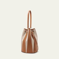 Altuzarra "Drum" bucket bag in canvas cotton and leather  Shoulder strap Drawstring closure  Approx. 9.5"H x 13"W x 9.5"D Made in Spain Designer Bucket Hobo Bag With Leather Handles, Canvas Bucket Satchel For Errands, Designer Bucket Bag With Leather Handles, Luxury Canvas Satchel Bucket Bag, Daily Use Bucket Hobo Bag With Leather Trim, Modern Bucket Shoulder Bag With Leather Trim, Canvas Satchel Bucket Bag With Detachable Handle, Canvas Bucket Satchel With Detachable Handle, Designer Beige Bucket Bag With Leather Handles