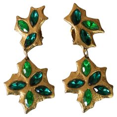 Superb vintage long clips earrings from French designer Carole Saint Germes who created for the fashion shows of the Givenchy couturiers, Feraud, Ungaro, and Jean Charles de Castelbajac. Earrings are gold plated and feature a lighter and darker tone of green faceted rhinestones. Approximate measurement: just under 4" long by just over 1.75" at widest point. Signed. Very good condition. Metal Drop, French Design, Givenchy, Clip On Earrings, Light In The Dark, Metallica, Jewelry Earrings, Drop Earrings, Green