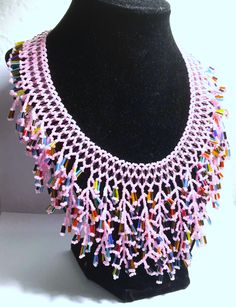 A handmade glass beaded necklace that is perfect for any occasion: parties, holidays, birthdays, anniversaries. All products are hand-crafted by my mother. Dimensions: - Actual Length: 30.0 cm - Collar Length: 22.0 cm - Width: 14.0 cm - Height: 2.0 cm Lightweight, high quality with a beaded toggle as a clasp. Will respond to concerns and suggestions promptly. Acrylic Pearls: 8 mm. Shipping costs: Free Domestic Shipping. All orders are sent by air-mail with tracking number. Time of delivery: Estimated 1-3 days for domestic shipping; international make take 7-14 days. Feel free to check out our other similiar products! Link: https://www.etsy.com/shop/NurKnitsNKrafts Glass Beaded Necklaces With Dangling Beads As Gifts, Handmade Beaded Necklaces With Round Beads For Celebration, Handmade Pink Beads For Party, Adjustable Colorful Beads Necklace For Celebration, Handmade Glass Beads For Jewelry Making, Unique Glass Beaded Necklaces As Gift, Artisan Necklace With Round Beads For Party, Unique Glass Beaded Necklaces For Gifts, Adjustable Colorful Beaded Necklaces For Celebration