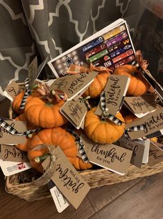 a basket filled with lots of small pumpkins