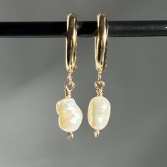 Our Freshwater Pearl Huggie Hoops are the perfect gift for her or gift for loved one! Made with 24k Gold Plated Stainless Steel, it is bound to last a long time with proper care! MATERIALS & COMPONENTS * Made with your choice of Silver Plated Stainless Steel Huggie Hoops, 925 Sterling Silver Wire & natural Mother of Pearl or 24k Gold Plated Stainless Steel Huggie Hoops & 14k Gold Filled wire. * Tarnish resistant * Skin friendly * 6-9mm Pearls  * Your choice of 16mm or 20mm Hoops JEWELLERY CARE Although Gold/Silver Plated Stainless Steel & 14k Gold Filled/Sterling Silver jewellery is water and tarnish resistant, we want your new fave hoops to last as long as posssible. * Avoid swimming in the sea & swimming pools * Avoid wearing your jewellery when showering and exercising * Put on perfumes Earrings Gold Pearl, Pearl Earrings Gold, Gold Pearl Jewelry, Chunky Pearls, Pearl Jewellery, Jewellery Gold, Steel Earrings, Old Jewelry, Stainless Steel Earrings