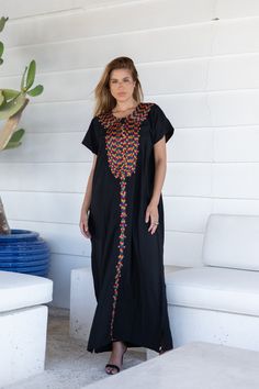 A bohemian flash caftan made of light mesh of linen and poly, the fabric is unique in that it's very flowy and not the usual feel and touch of linen. This Kaftan is ideal to wear for any casual occasion. Whether taking a trip down the shopping lane, or home-based kitty parties, or about anything else, wearing this dress will make you feel classy and comfortable. Fabric : 50% Linen, 50% Polyester. Please note that the fabric on this Kaftan has some weight to it and is meant to give off that crumb Traditional Black Maxi Length Thobe, Black Floral Embroidered Beach Maxi Dress, Bohemian Black Thobe For Eid, Traditional Long Black Kaftan, Black Embroidered Maxi Dress For Eid, Black Bohemian Embroidered Abaya, Black Beach Dress For Eid, Floral Embroidered Maxi Dress For Beach Cover-up, Black Kaftan For Eid