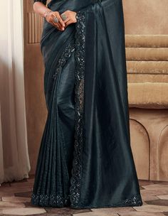 COLOR : Shimmer Peacock Black FABRIC : Saree - Fancy Silk, Blouse - Fancy Silk & Net WORK : Resham Embroidery, Stones, Sequins, Lace BorderOCCASION : Wedding, Engagement, Party Wear, Festival, Sangeet NOTE : The outfit includes blouse and saree only. Petticoat is not included. READY-TO-WEAR : No STITCHING : Available as semi-stitched fabric, can be stitched using standard size option (+$30). Note: There might be a slight color variation due to lighting and flash used during photoshoot. The bright shade seen is the best closer view of fabric's color. Black Wedding Party, Embroidery Stones, Saree Fancy, Resham Embroidery, Wedding Party Wear, Party Wear Saree, Wear Saree, Silk Wedding, Party Wear Sarees