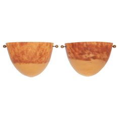 two brown bowls sitting side by side on top of each other in front of a white background