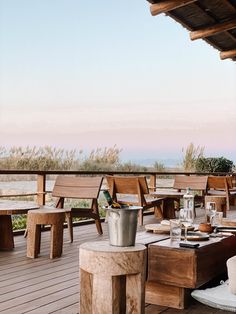 an outdoor dining area with wooden tables and benches