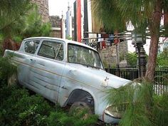 an old car is sitting in the bushes