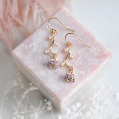 "Light Purple Flower Earrings // Gold Filled Earrings // Boho Bridal Earrings // Floral Earrings // February Birthstone // Birth Flower // Wild Flower Earrings // Birthday Gift // Gift for Mom :: Provide an enchanting effect with these fresh floral earrings :: These light purple flower earrings are a delicate and feminine design perfect for any boho wedding attire or for adding a little sparkle to your next special occasion. The tiny purple flower petals are created with faceted glass and secured to golden stems featuring small cubic zirconia leaves. The wild flower earrings are light weight and suspended from comfortable 14k gold filled earrings. Whether adding these flower earrings for a lovely touch of color and sophistication to your wedding day these will arrive suitably gift wrapped Boho Wedding Attire, Purple Flower Petals, Boho Bridal Earrings, Boho Bridal Jewelry, Light Purple Flowers, Flower Earrings Gold, Purple Birthday, Greenwich Ct, Gold Filled Earrings