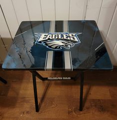 a glass table with the philadelphia eagles logo on it