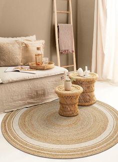 two wicker tables sitting on top of a white floor next to a ladder in a living room