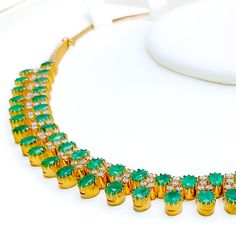 This exquisite 18k yellow gold necklace set, weighing 41.8 grams, features a luxurious design adorned with dazzling diamonds and vibrant emeralds. The yellow gold finish enhances its elegant appeal, making it perfect for any special occasion. The set includes a necklace with a total diamond weight of 2.95 carats, featuring F-G color and VS quality diamonds. The necklace has a length of 15 inches with adjustable 1.1-inch links and is secured with a hook lock. The matching earrings, each measuring Elegant Hand-set Emerald Necklace In Yellow Gold, Elegant Yellow Gold Hand Set Emerald Necklace, Emerald Necklace With 17 Jewels For Celebration, Luxury Hand Set Round Emerald Necklace, Luxury Hand-set Round Emerald Necklace, Luxury Yellow Gold Emerald Necklace For Wedding, Luxury Hand-set Emerald Necklace For Celebration, Luxury Gold Plated Emerald Necklace With Gemstones, Exquisite Gold Emerald Necklace Hand Set