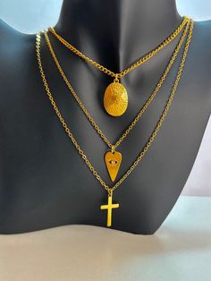 - Gold plated stainless steel 3 layer chain necklace with cross ,heart, oval medallion charms - Cross, heart charms are gold plated stainless steel, oval medallion charm is 24K gold plated - The length of necklace is 55 cm (21.7 inches), extend 5 cm (2 inches) - Colors may appear slightly different on screen due to differences in resolution, brightness, and contrast JEWELRY CARE - Keep jewelry dry - Take it off before taking shower, bath, swimming or exercising - Makeup, perfume, hairspray apply Trendy Tarnish Resistant Alloy Jewelry, Trendy Alloy Tarnish-resistant Jewelry, Trendy Tarnish-resistant Alloy Jewelry, Trendy Dangle Stainless Steel Jewelry, Metal Cross Jewelry With Adjustable Chain, Stainless Steel Dangle Clavicle Chain Jewelry, Stainless Steel Clavicle Chain Dangle Jewelry, Trendy Stainless Steel Dangle Jewelry, Gold Metal Cross Charm Necklaces