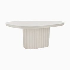 an oval white table with pleated edges and a circular base, on a white background