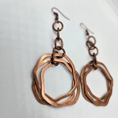 These unique vintage copper dangle earrings are the perfect touch of boho chic to any outfit, these earrings make a statement while adding a touch of elegance. Stand out from the crowd and add these must-have earrings to your collection today! Vintage Copper Dangle Details: vintage copper design 3 copper rings denim perfect great gift idea boho chic 3" drop Handmade Copper Drop Earrings, Copper Chandelier Dangle Earrings For Pierced Ears, Bronze Dangle Metal Earrings, Unique Bronze Copper Wire Earrings, Nickel-free Rust Drop Earrings, Nickel-free Rust-colored Metal Jewelry, Unique Rose Gold Metal Earrings, Bohemian Rose Gold Nickel-free Jewelry, Unique Rose Gold Earrings