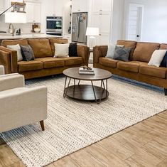 a living room with couches, chairs and a coffee table in front of an oven