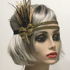 This stunning 1920's Downton Abbey vintage inspired Art Deco flapper headband is the perfect accompaniment for any styled event. I've designed and created this of a kind headband so feminine and romantic. Made with two rows of a black and gold woven trim backed with satin elastic. This headpiece features black and antique gold Ostrich feathers embellished with a Vintage Inspired Antique Brass Bow brooch with Gold Rhinestones.  I have designed and created each piece from my smoke-free studio. All pieces are securely wrapped and boxed to prevent damage/breakage. Ready to ship.  Feel free to convo me if you have any questions. Thank you very much for visiting my shop. Have a blooming day! Vintage Adjustable Fascinator Headband, Flapper Style Fascinator Headband For Party, Gold Headband Headpieces For Carnival, Vintage Headband Costume Hat For Party, Vintage Costume Headband For Party, Vintage Adjustable Costume Hats And Headpieces For Party, Vintage Adjustable Costume Hat For Costume Party, Vintage Adjustable Costume Accessories For Costume Party, Elegant Carnival Headband Headpiece