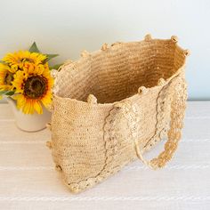 Bohemian Natural Bucket Shoulder Bag, Artisan Crochet Bucket Bag In Natural Color, Bohemian Natural Color Bucket Shoulder Bag, Fair Trade Straw Bag For Travel, Bohemian Open Weave Natural Shoulder Bag, Artisan Jute Straw Bag, Bohemian Ethically Sourced Beach Bag, Bohemian Straw Shoulder Bag For Market, Artisan Straw Travel Bag With Natural Fiber