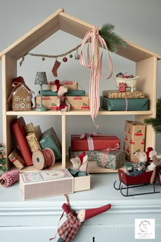 a shelf filled with lots of presents under a christmas tree