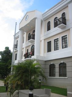 a large white building with lots of windows and balconies on the second floor