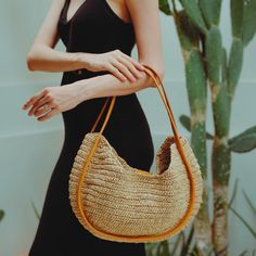 A sturdy double leather straps wrap the edge trim on the front and back of this roomy tote bag handwoven from raffia in a slightly slouchy silhouette to carry all your essentials. Perfect for the beach day and your summer road trips. Wipe clean with a damp cloth. Material: Raffia body and Leather handles. Chic Brown Straw Bag With Rolled Handles, Chic Natural Hobo Bag With Braided Handles, Chic Everyday Handwoven Hobo Bag, Chic Everyday Straw Bag With Woven Leather, Chic Jute Straw Bag With Round Handle, Vacation Shoulder Bag With Woven Leather And Round Handle, Chic Woven Leather Bucket Bag, Chic Woven Leather Shoulder Bag, Chic Handwoven Hobo Bag For Everyday