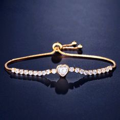 Delicate and elegant, this adjustable heart bracelet will add a touch of sophistication to any wedding gown or formal ensemble. Adorned with heart-shaped cubic zirconia that captures the light from every angle with a perfectly translucent appeal, the bracelet is rhodium / rose gold / yellow gold plated for a flawless finish which perfectly enhances the intricate detailing and conveys a modern take on old elegance. The bracelet measures 0.4" (approx. 1cm) at the widest point, and the adjustable c