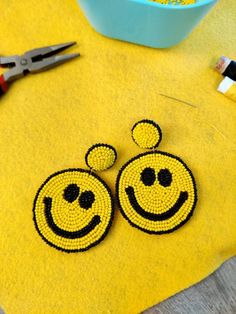 Perfect statement earrings for this festive season. Smiley happy face earrings will bring smiles to everyone that's around you! Beaded earrings for the festive season are available now at our shop. They are totally handmade and eye-catchy and are ready to rock your New Year's eve parties or any other party. These seed beads earrings have felt back and are very light-weighted. Please message me for bulk orders For more collection check out our full range of handmade products at https://www.etsy.c Beaded Smiley Face, Trendy Handmade Yellow Beaded Earrings, Cheerful Handmade Jewelry Gift, Cute Handmade Yellow Earrings, Trendy Yellow Beaded Earrings - Gift Idea, Trendy Yellow Beaded Earrings As Gift, Trendy Yellow Beaded Earrings For Gift, Cheerful Smiley Face Jewelry As Gift, Handmade Yellow Fun Earrings