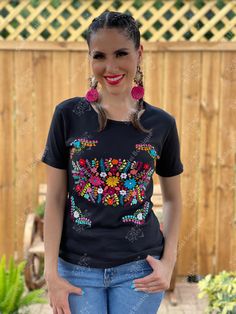 This Beautiful Floral embroidered t-shirt is made out of soft cotton and is perfect for every day use. It is cute, comfortable, and versatile. This Mexican T-shirt is hand embroidered and made with love by Mexican Artisans in Guanajuato, Mexico. Purchase the Artisanal Earrings here: https://www.etsy.com/es/listing/918692155/aretes-mexicanos-de-corazon-con-flor-de?ref=listings_manager_grid Multicolor Embroidery Short Sleeve Tops For Festival, Short Sleeve Cotton Embroidered Top For Festivals, Casual Tops With Multicolor Embroidery And Motif, Bohemian Short Sleeve Top With Multicolor Embroidery, Casual Multicolor Tops With Geometric Embroidery, Casual Multicolor Embroidered Top With Short Sleeves, Traditional Cotton T-shirt For Summer, Traditional Crew Neck Embroidered Cotton Top, Festival Cotton Tops With Floral Embroidery