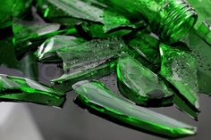 some green glass pieces with water droplets on them